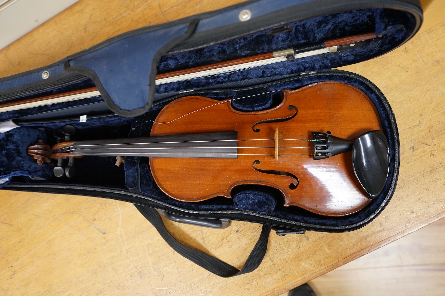 A cased late 19th century violin, signed ‘Nicolas Bertolini’, back 36.3cm, with bow stamped Paesold, CITES Submission reference, D9GSYMLJ